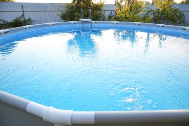 Photo of Above ground swimming pool in garden, closeup