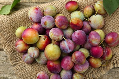 Photo of Tasty ripe plums on table, flat lay