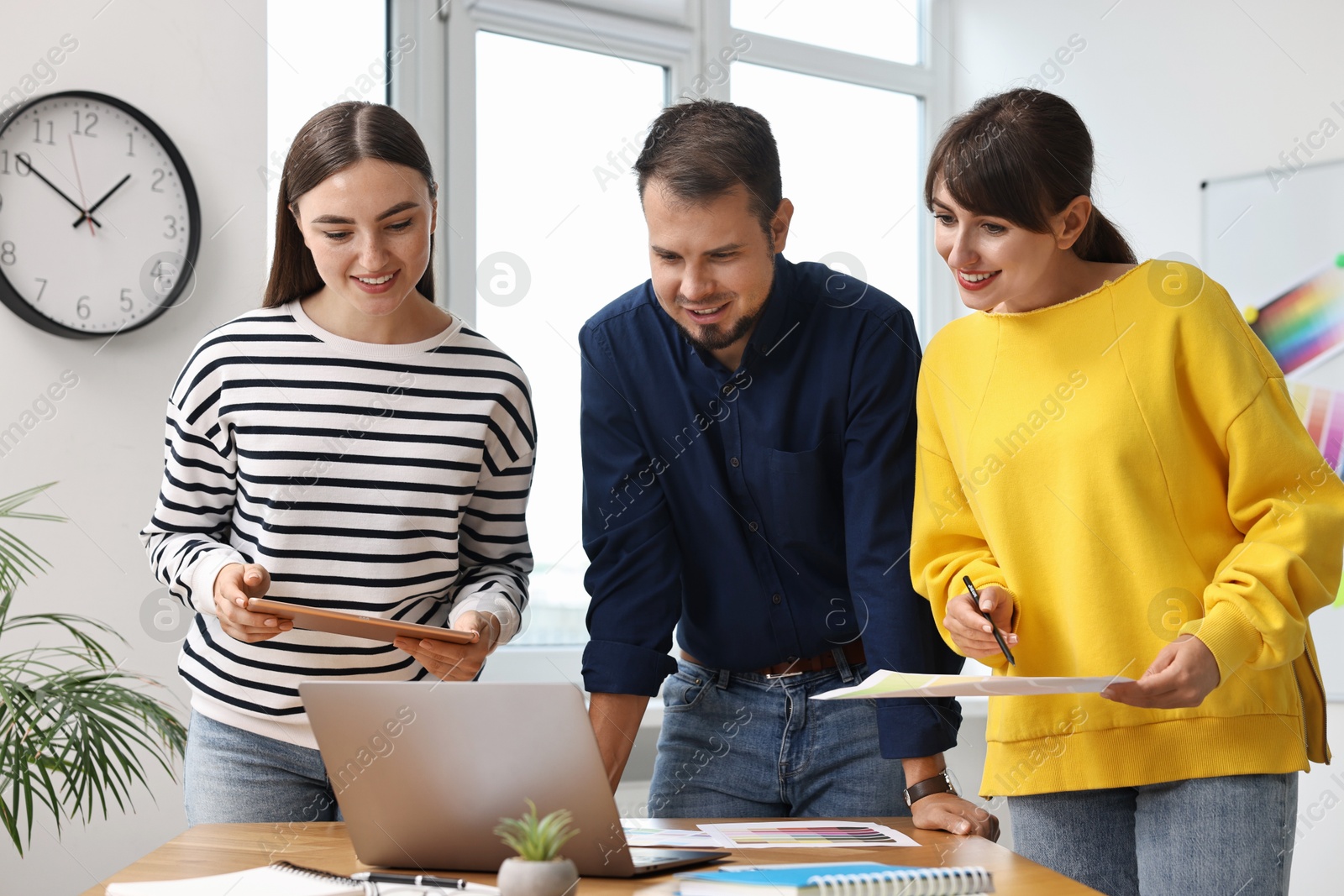 Photo of Group of designers working together in office