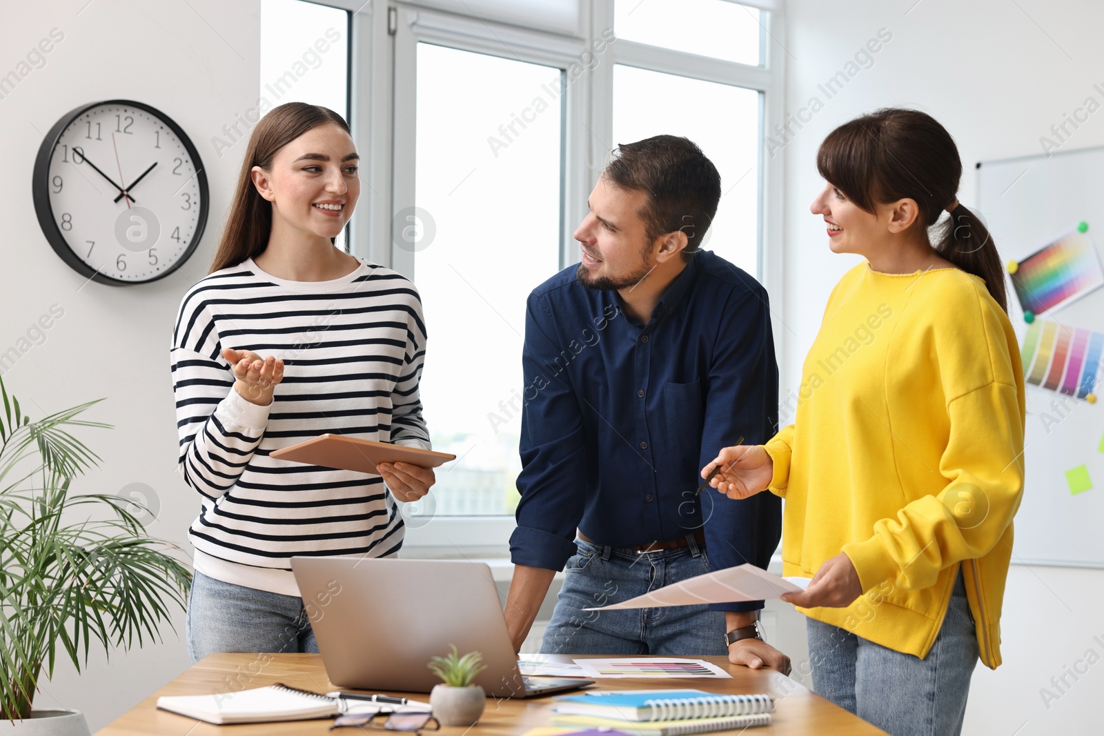 Photo of Group of designers working together in office