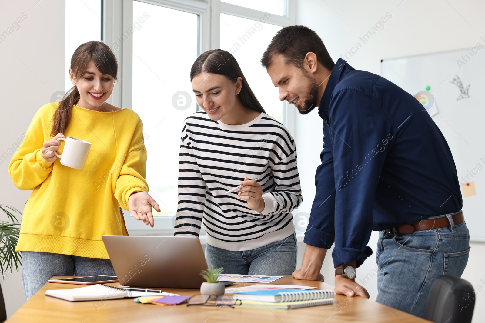 Photo of Group of designers working together in office