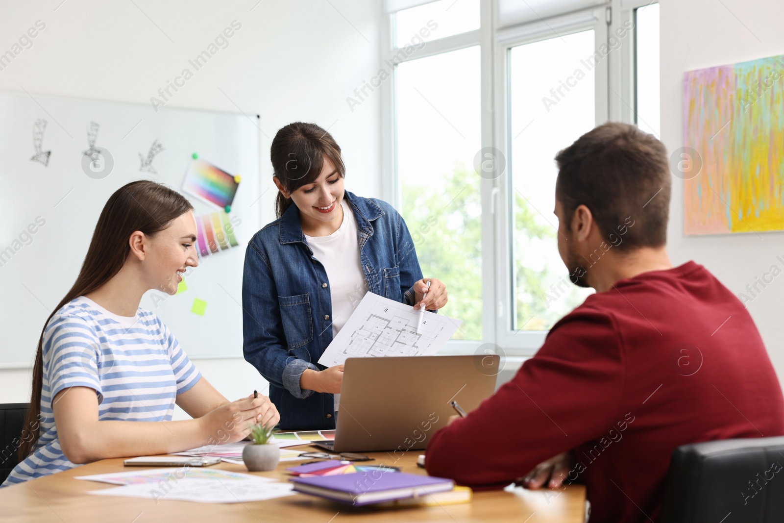 Photo of Group of designers working together in office