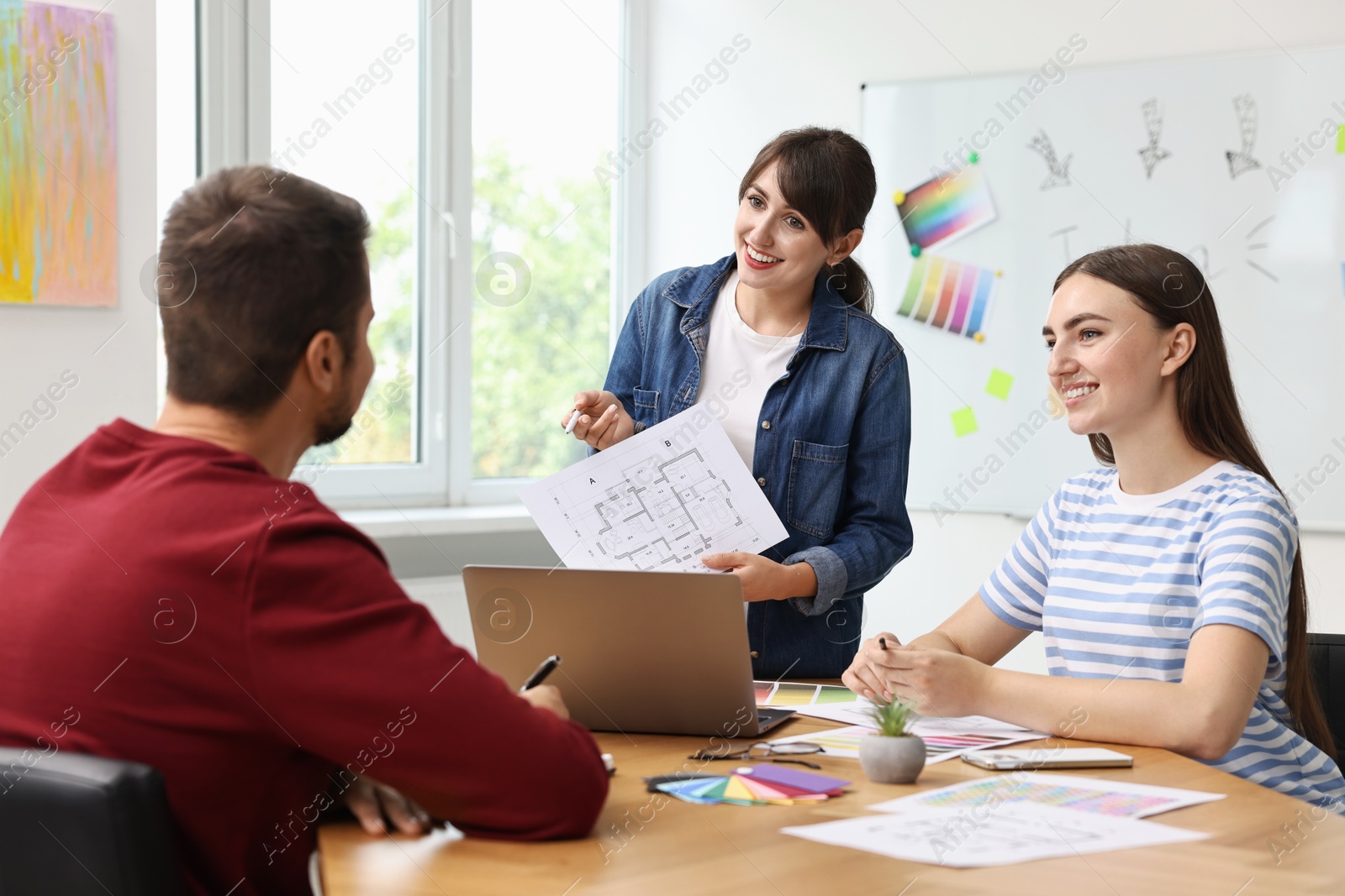 Photo of Group of designers working together in office