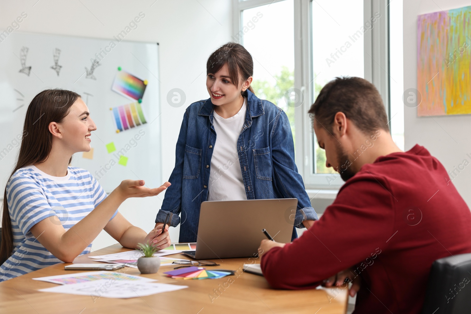 Photo of Group of designers working together in office