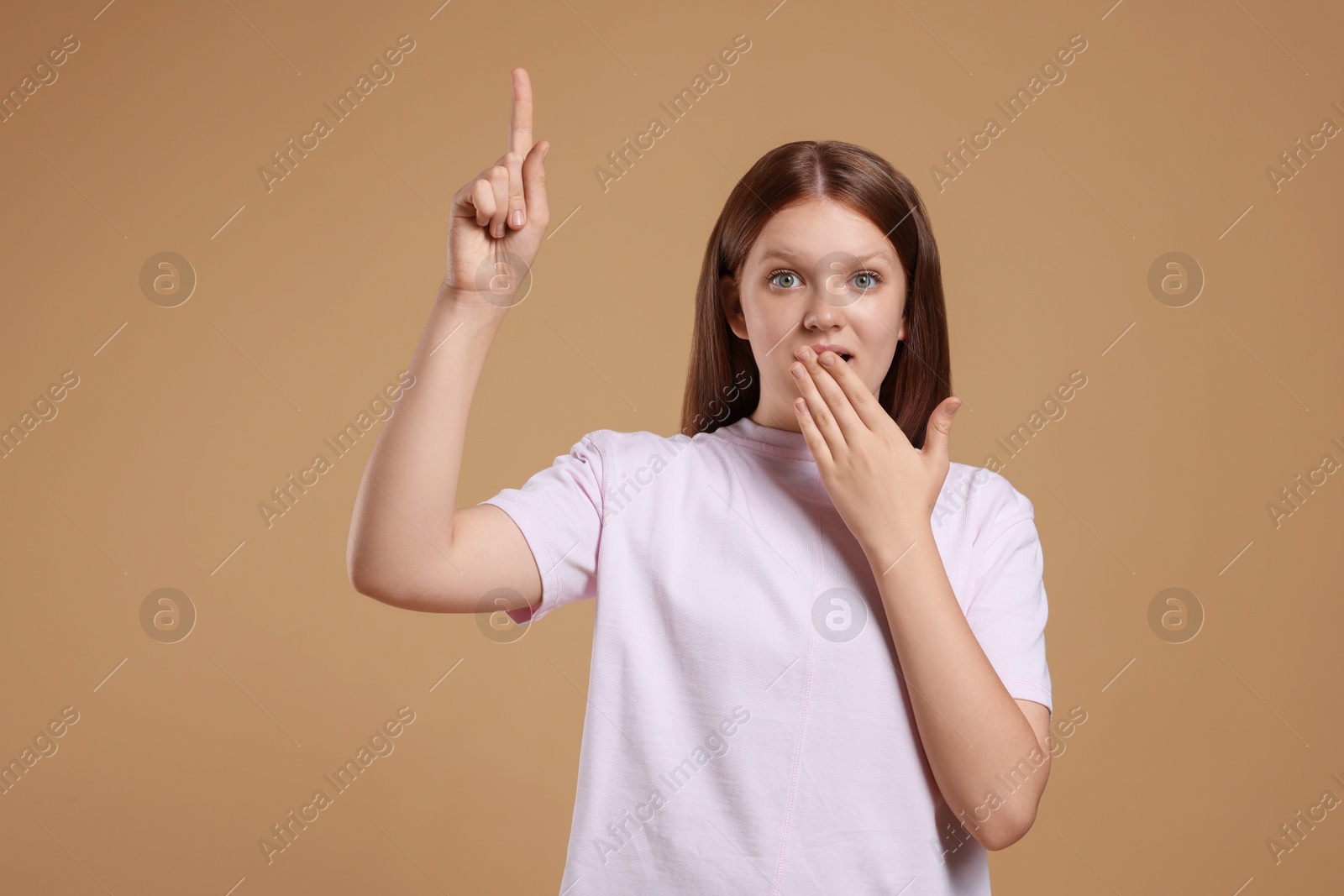 Photo of Portrait of teenage girl on beige background