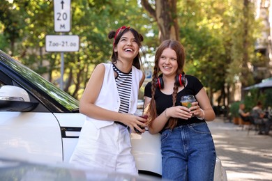 Happy teenage friends spending time together outdoors