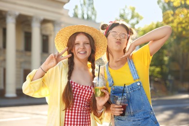 Happy teenage friends posing on city street