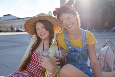 Portrait of happy teenage friends on city street