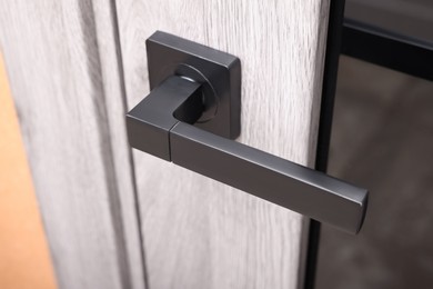 Photo of View of door with modern handle, closeup