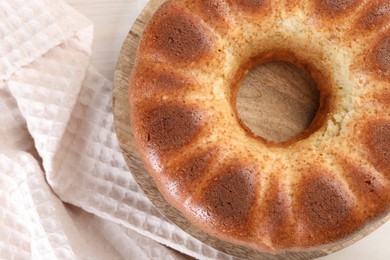 Freshly baked sponge cake on table, top view