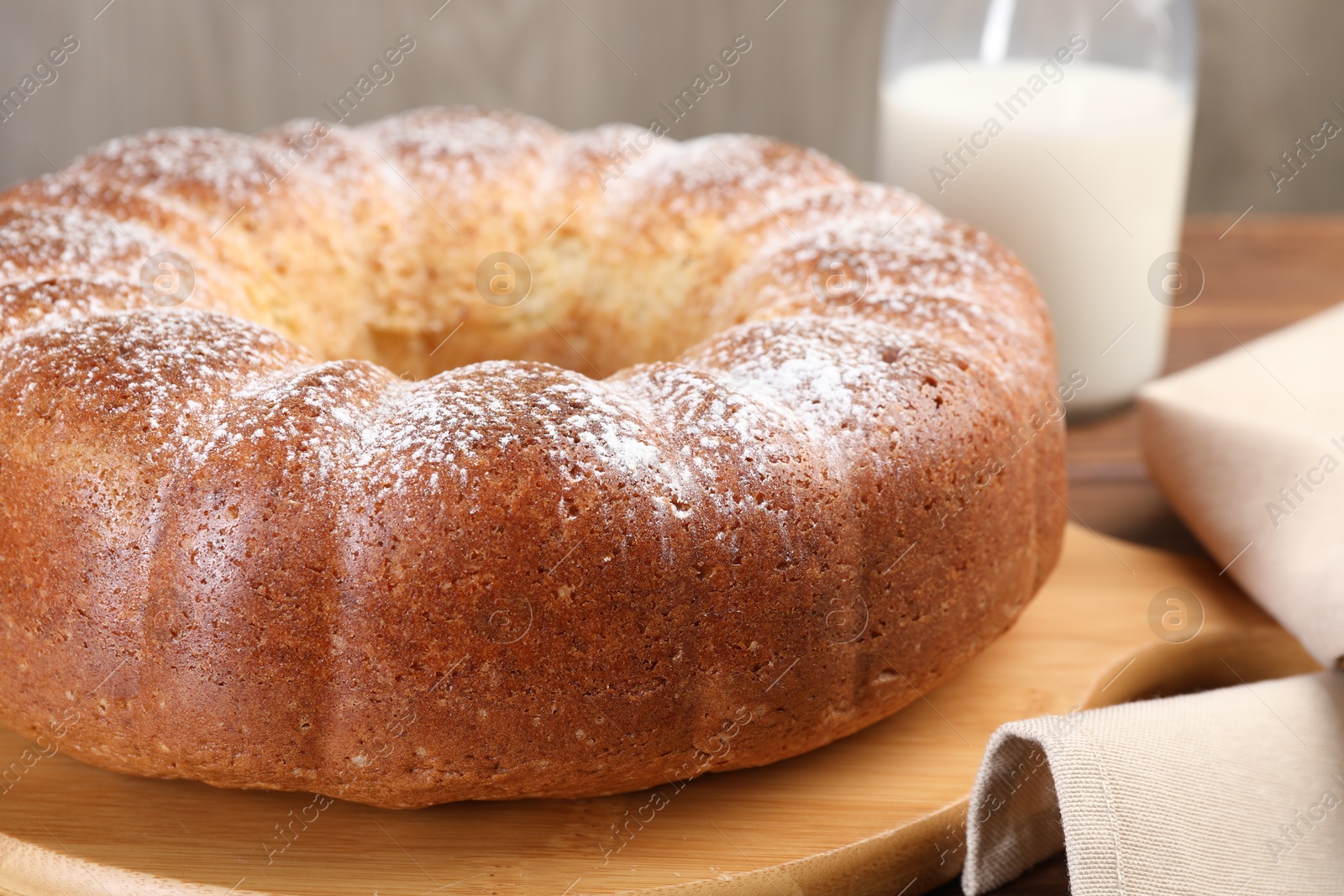 Photo of Freshly baked sponge cake and milk on table, closeup