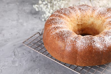 Freshly baked sponge cake on grey table, closeup