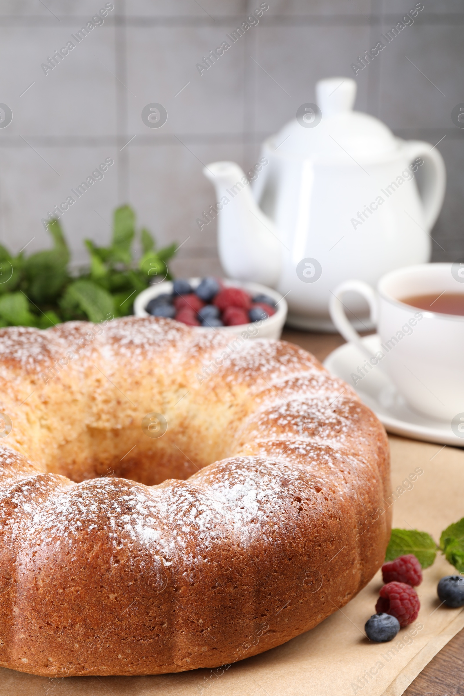 Photo of Freshly baked sponge cake and berries on table, closeup