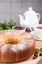 Freshly baked sponge cake and berries on table, closeup