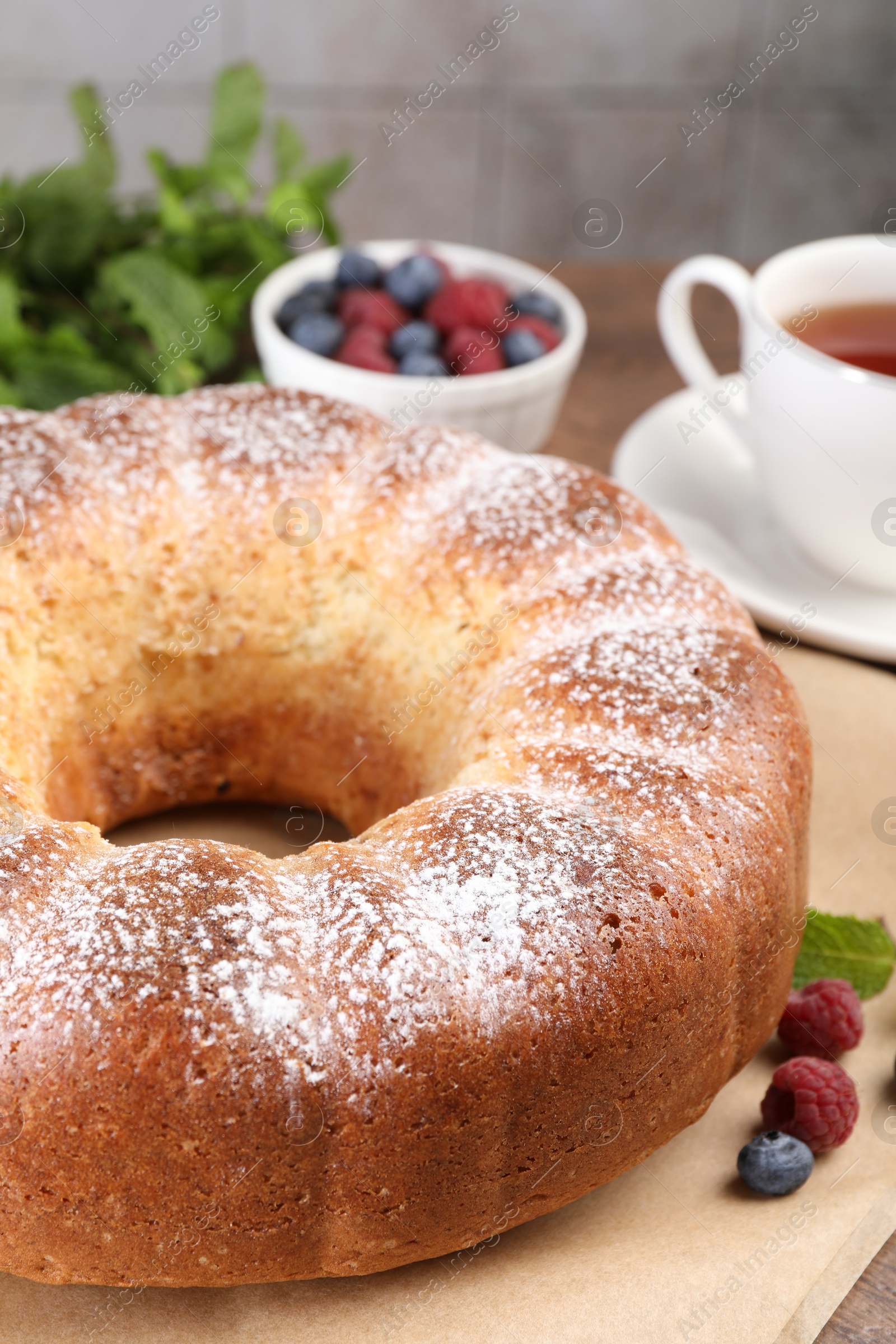 Photo of Freshly baked sponge cake and berries on table, closeup