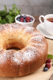 Freshly baked sponge cake and berries on table, closeup