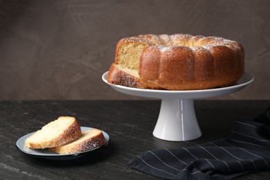 Photo of Freshly baked sponge cake on black table