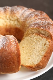 Photo of Freshly baked sponge cake on stand, closeup