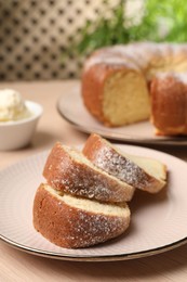 Photo of Pieces of freshly baked sponge cake on table, closeup