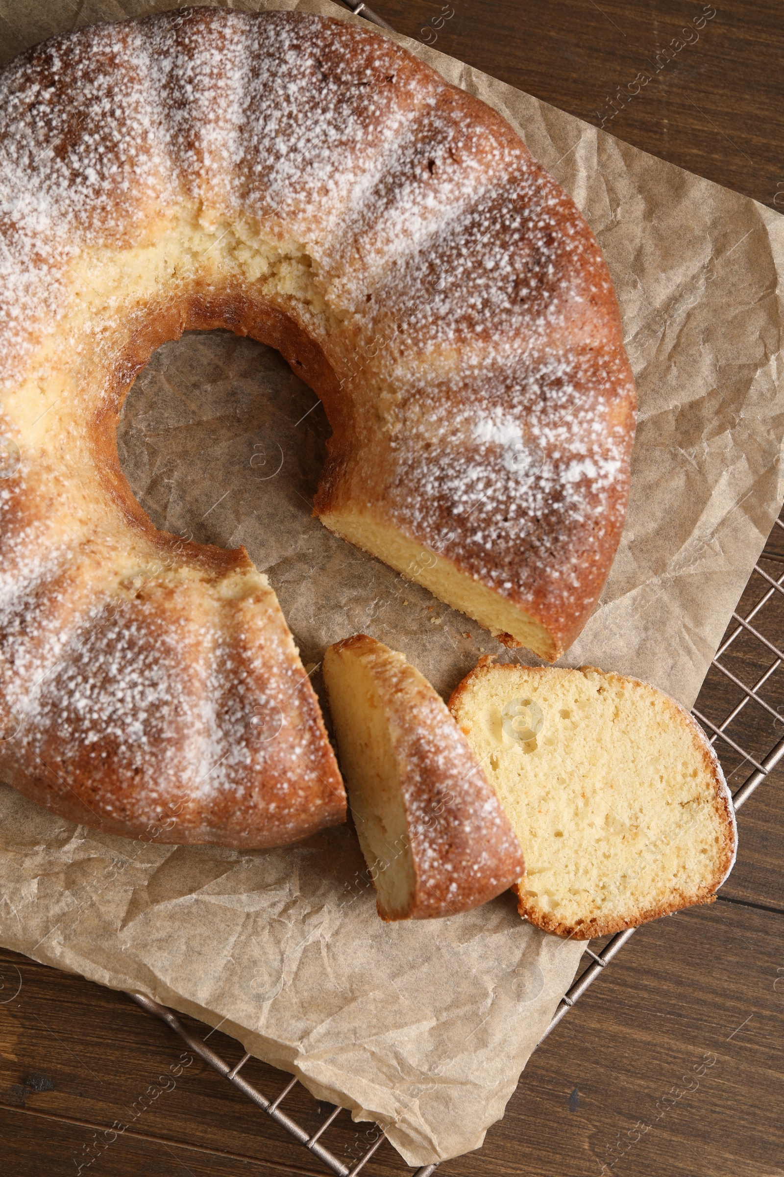 Photo of Freshly baked sponge cake on wooden table, top view