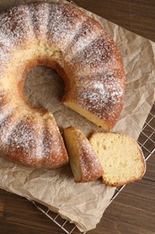 Freshly baked sponge cake on wooden table, top view