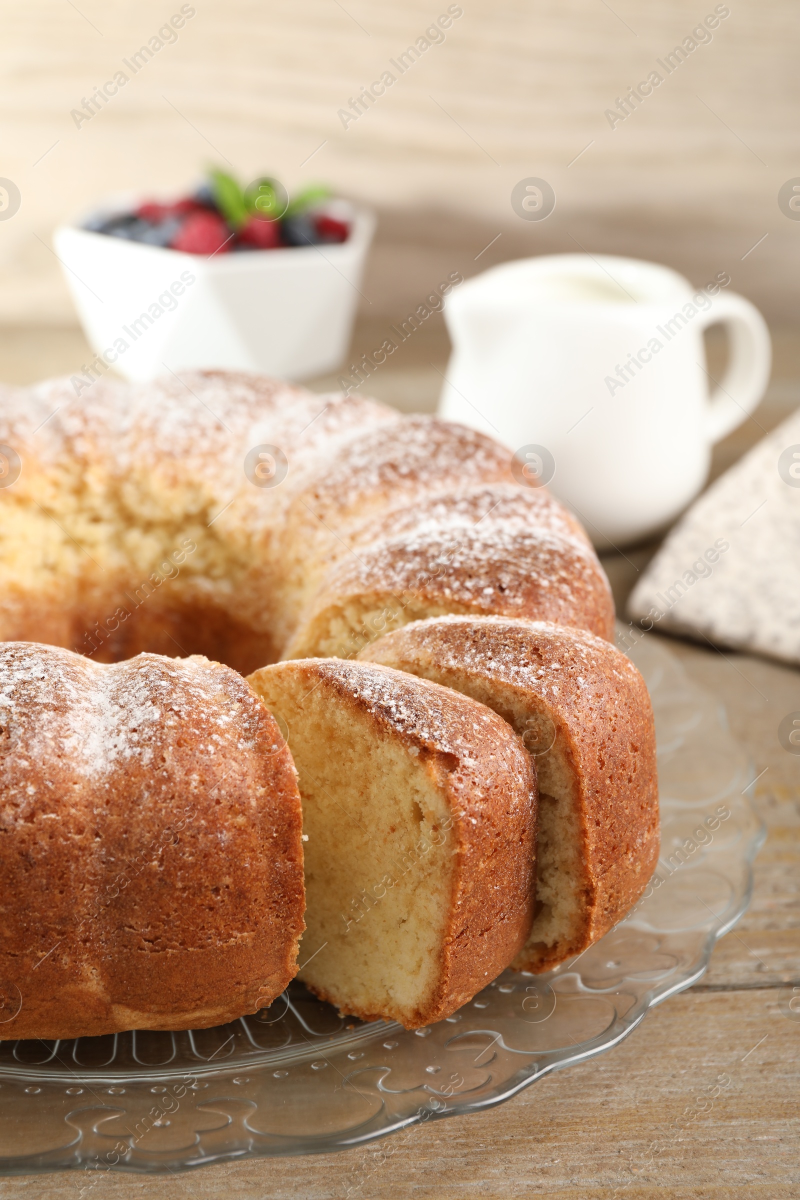 Photo of Freshly baked sponge cake on wooden table, closeup