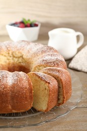 Freshly baked sponge cake on wooden table, closeup