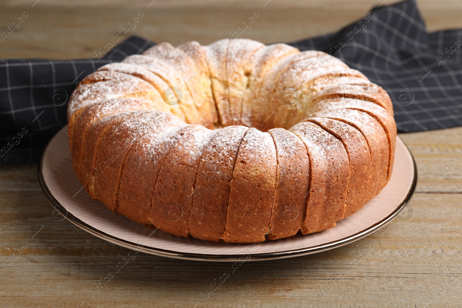 Photo of Freshly baked sponge cake on wooden table, closeup