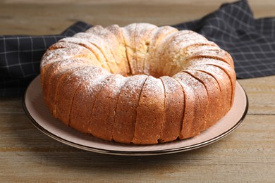 Freshly baked sponge cake on wooden table, closeup