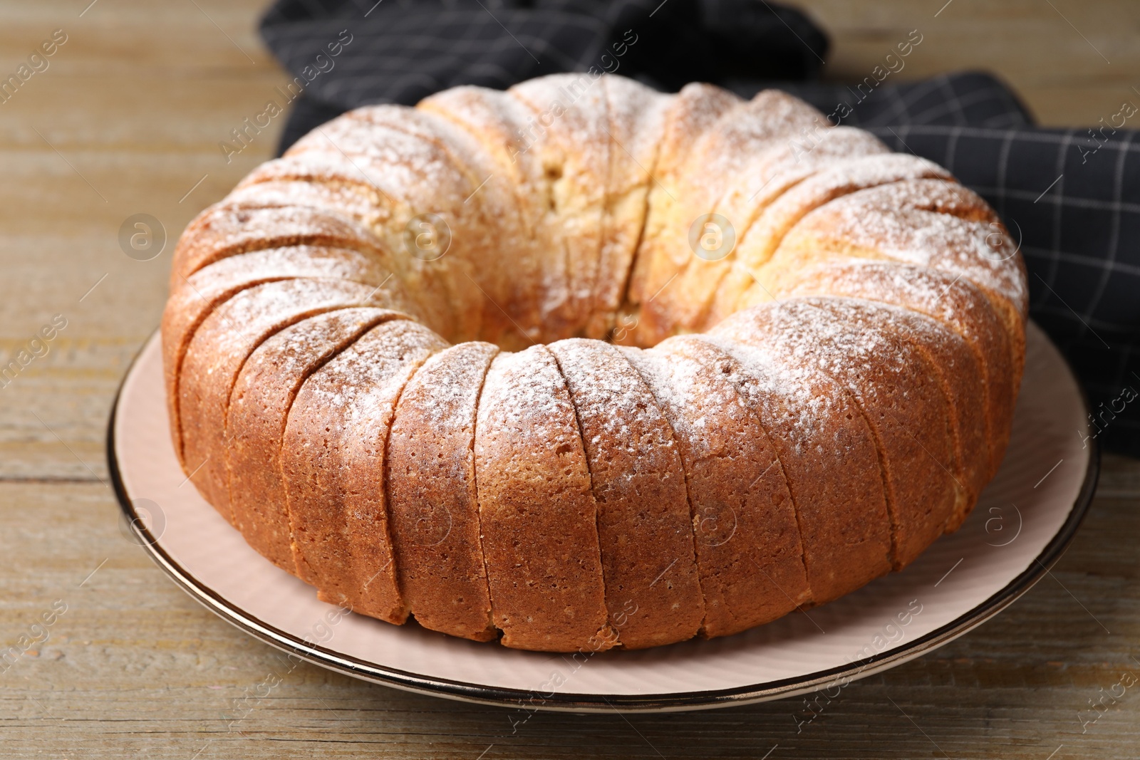 Photo of Freshly baked sponge cake on wooden table, closeup