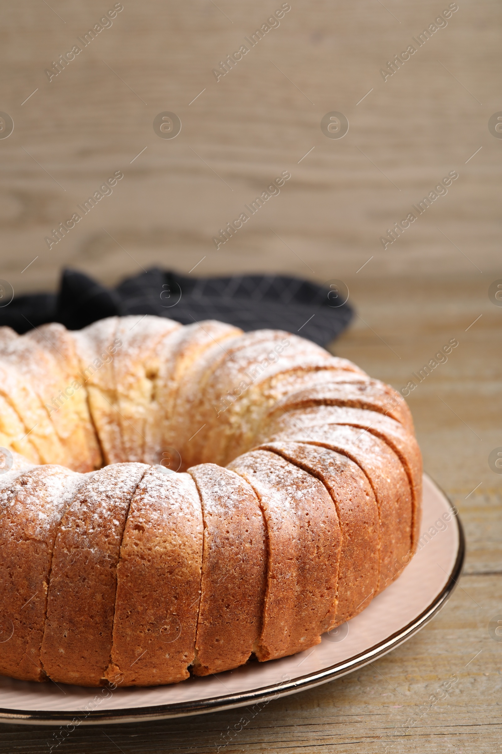 Photo of Freshly baked sponge cake on wooden table, closeup