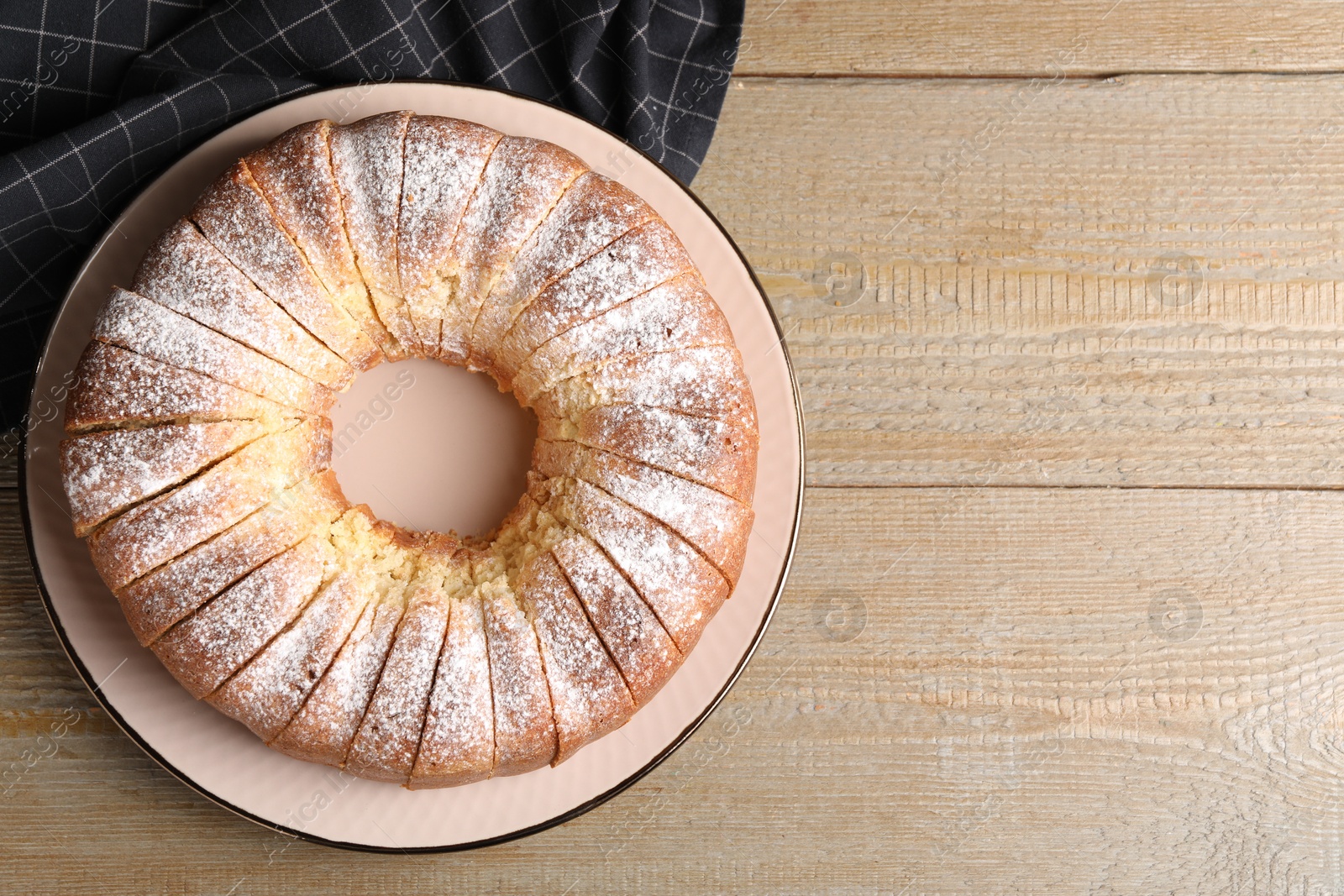 Photo of Freshly baked sponge cake on wooden table, top view. Space for text