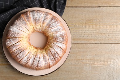 Photo of Freshly baked sponge cake on wooden table, top view. Space for text