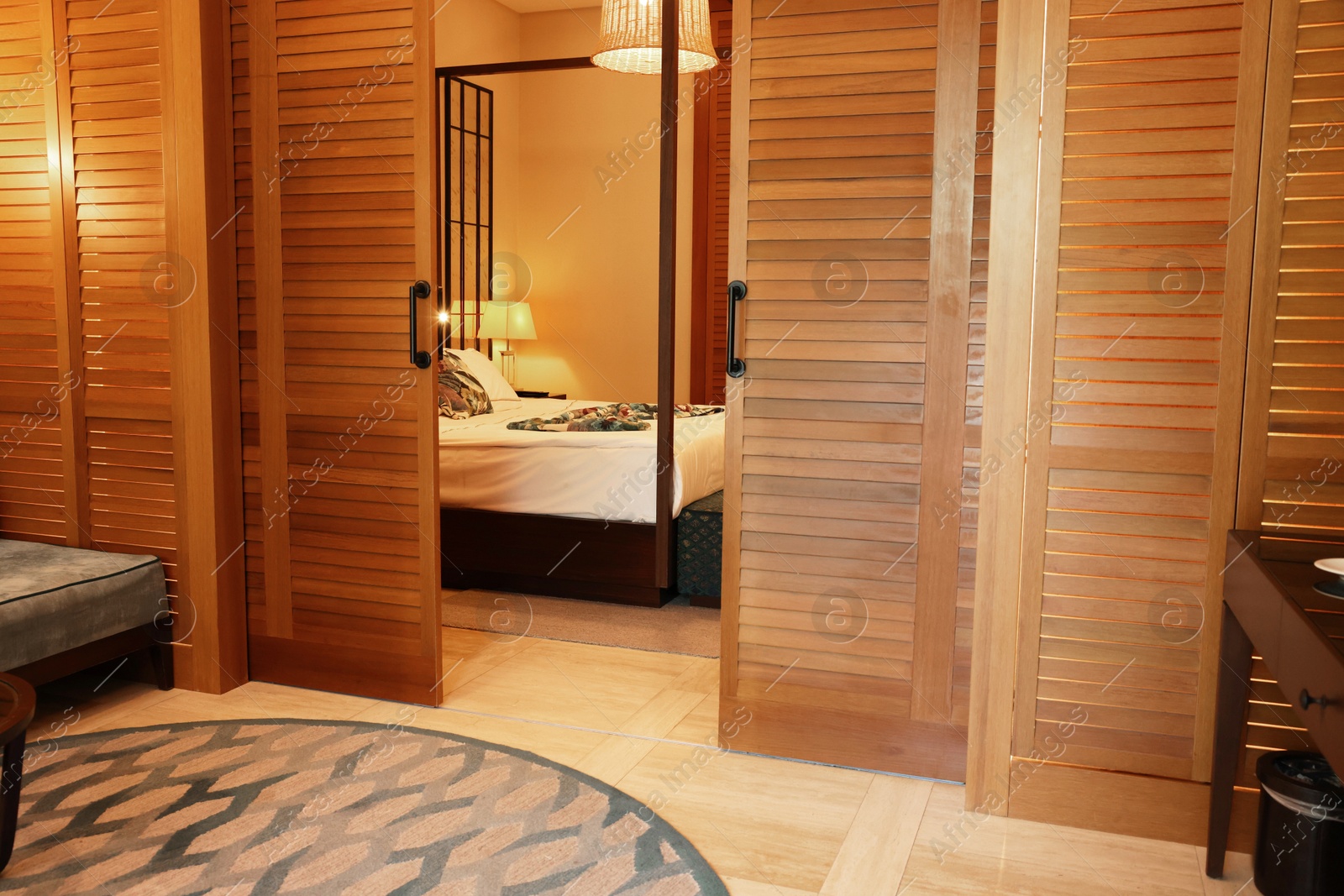 Photo of Stylish wooden sliding doors in hotel room