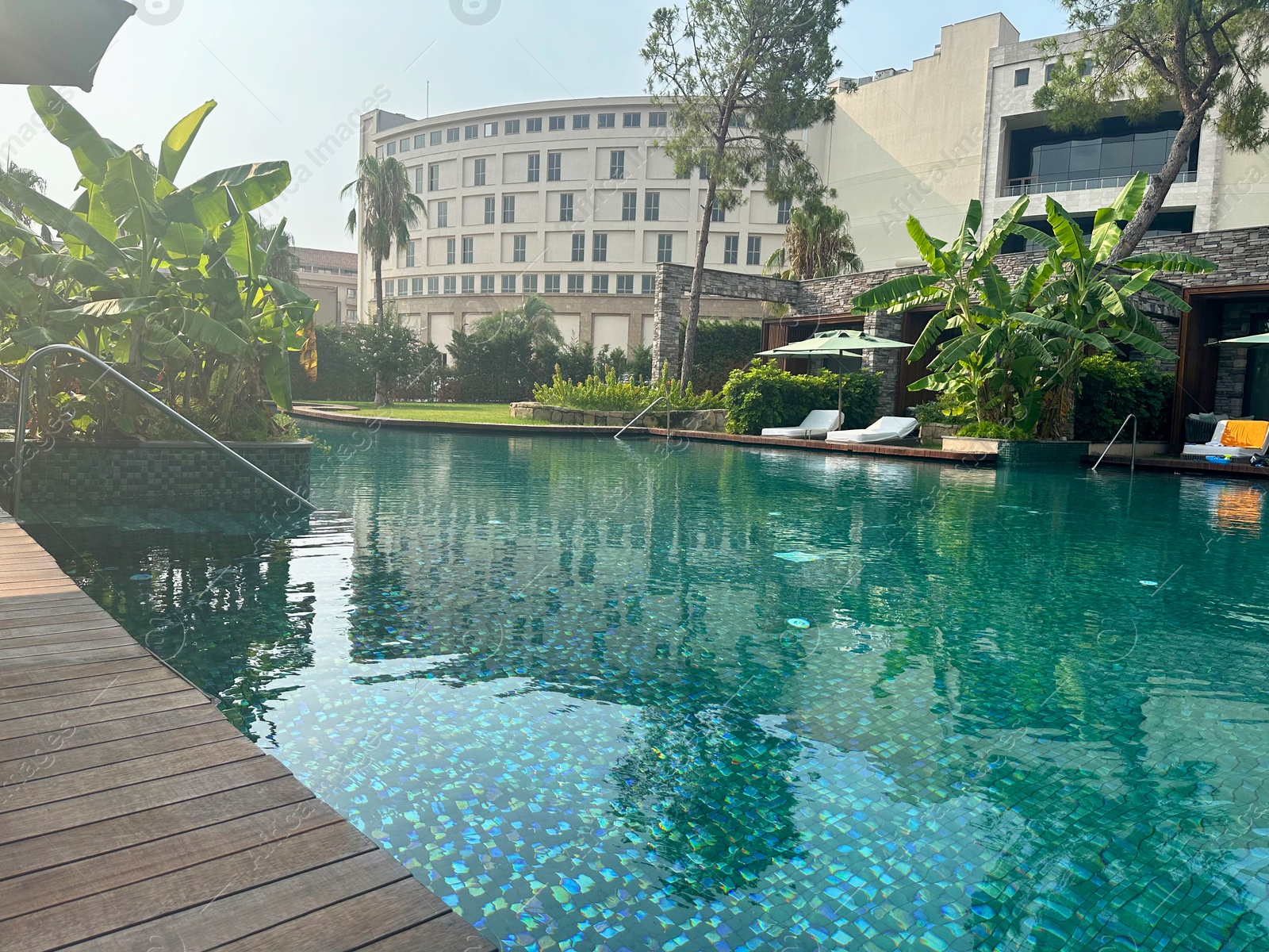 Photo of Outdoor swimming pool with clear water at luxury resort