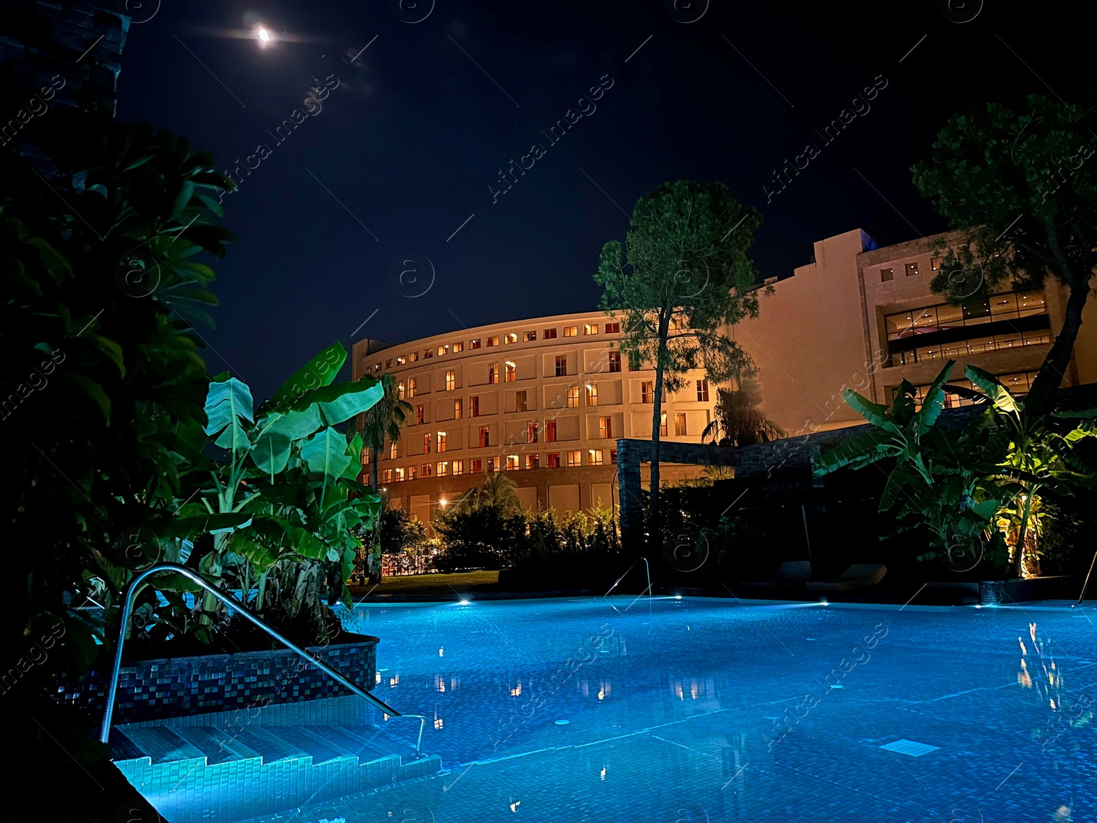 Photo of Beautiful view of swimming pool near luxury hotel at night