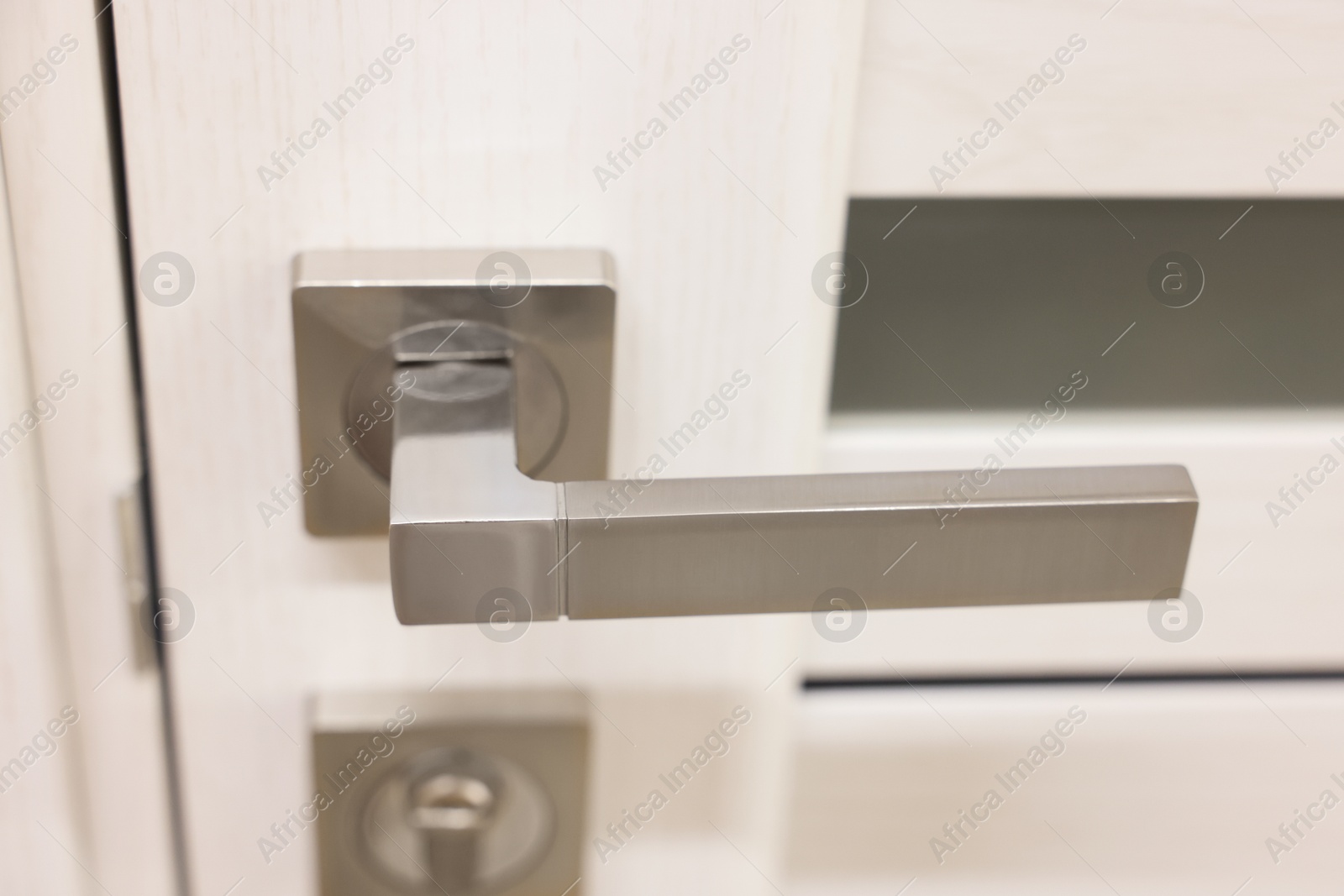 Photo of Wooden door with metal handle, closeup view