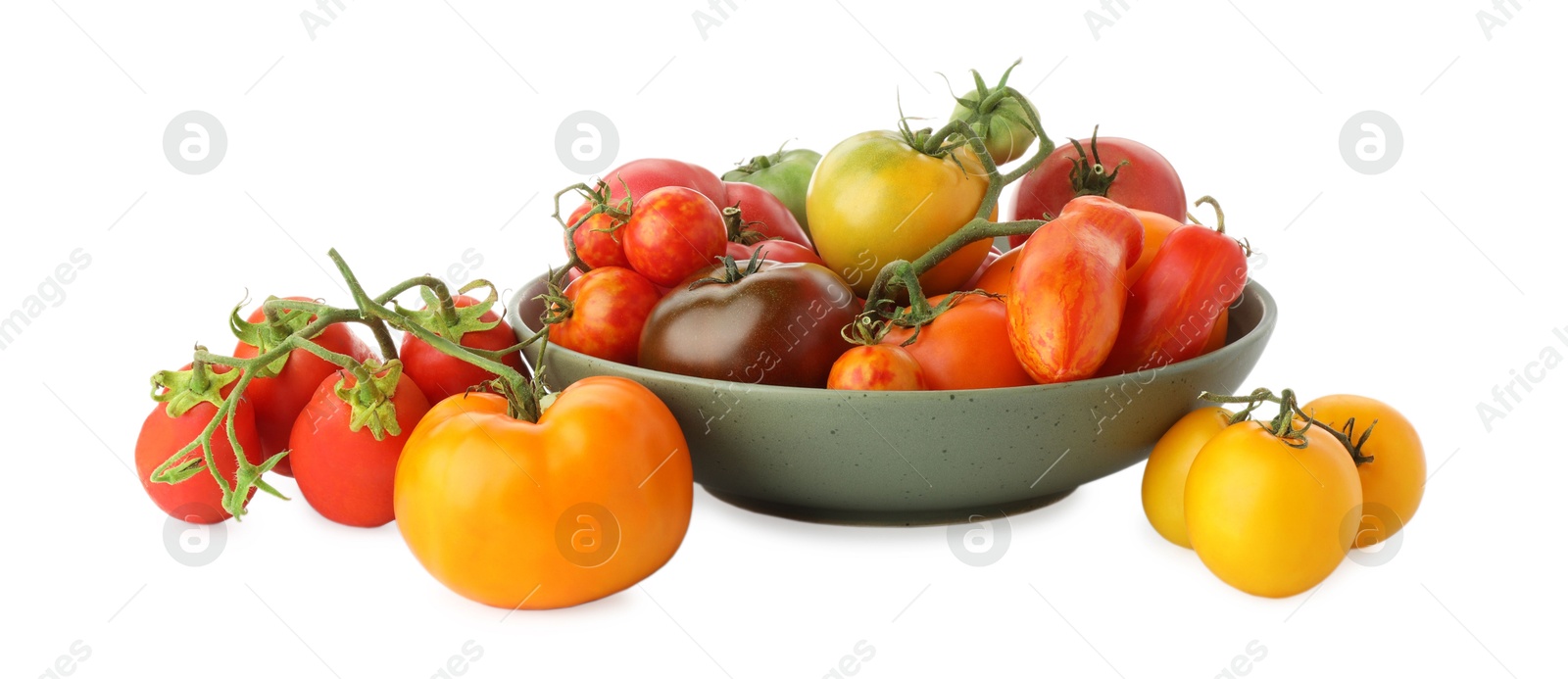 Photo of Different ripe tomatoes in bowl isolated on white