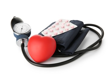 Blood pressure measuring device, pills in blisters and red decorative heart isolated on white