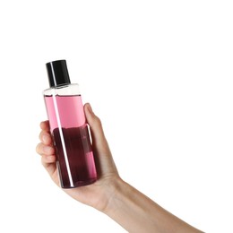 Woman with shampoo bottle on white background, closeup