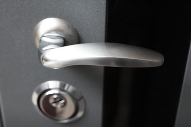 Photo of View of door with modern metal handle, closeup