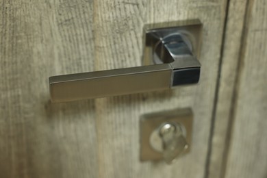 Photo of View of door with modern metal handle, closeup