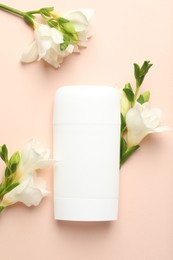 Photo of Solid deodorant and beautiful eustoma flowers on beige background, flat lay