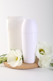 Photo of Different deodorants and beautiful eustoma flowers on white background