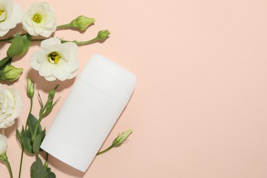 Photo of Solid deodorant and beautiful eustoma flowers on beige background, flat lay. Space for text