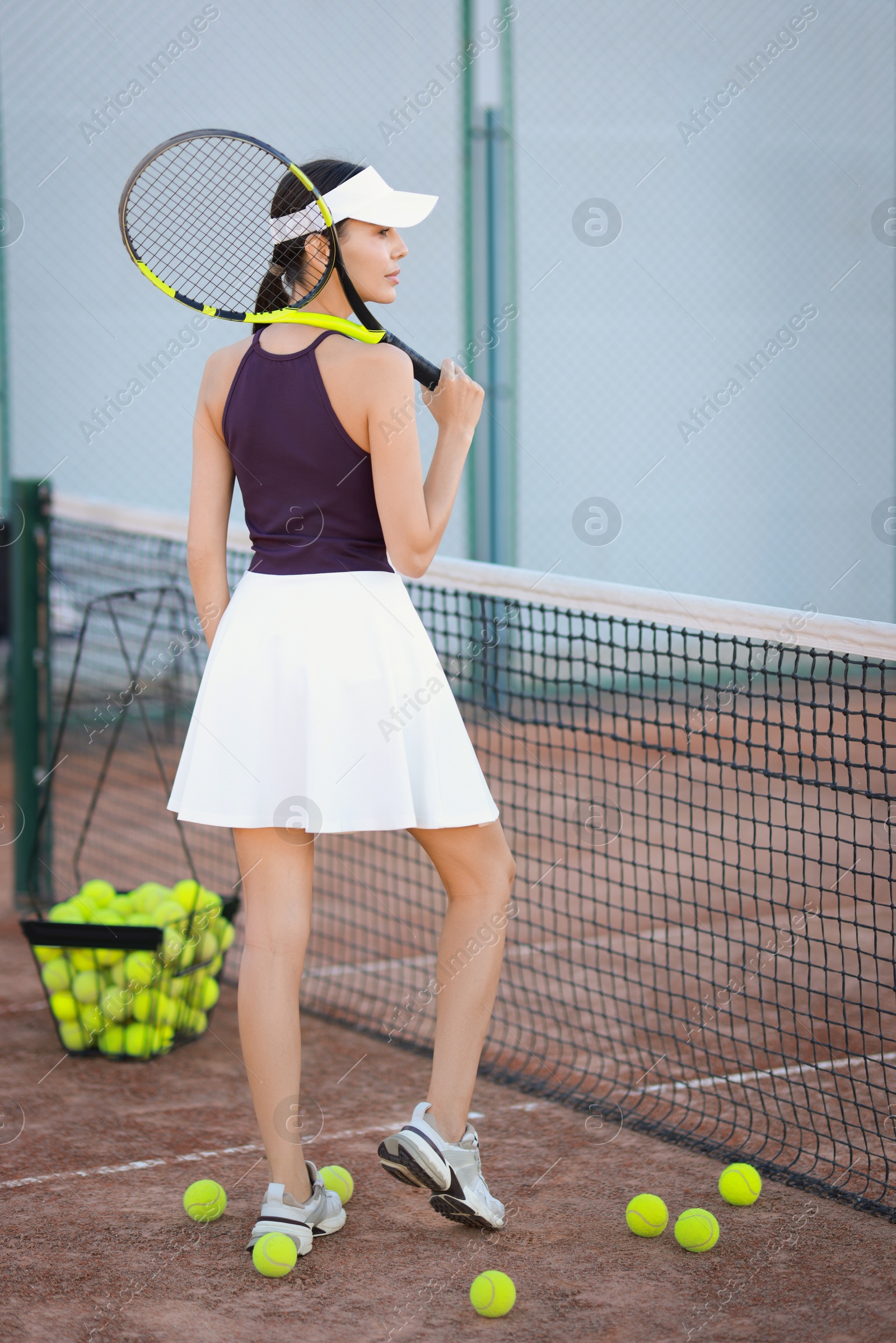 Photo of Beautiful woman with tennis racket on court