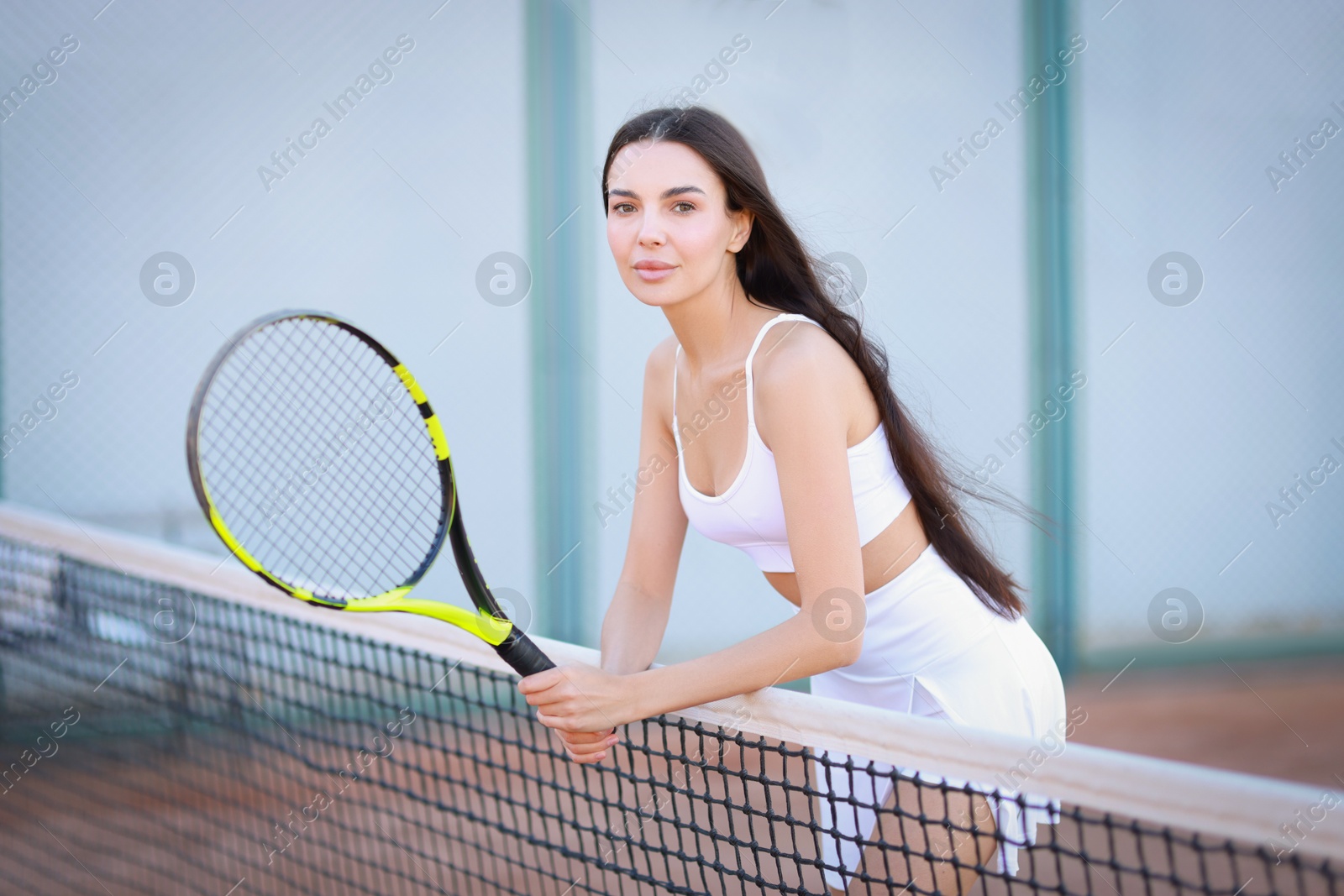 Photo of Beautiful woman with tennis racket on court