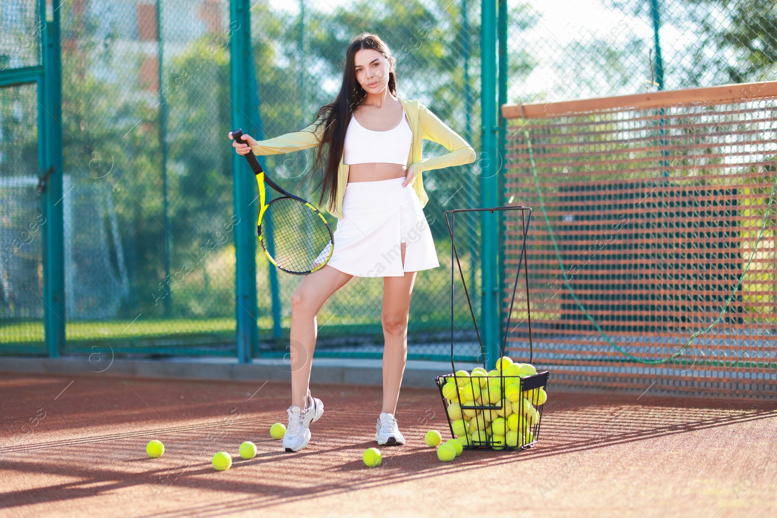 Photo of Beautiful woman with tennis racket on court