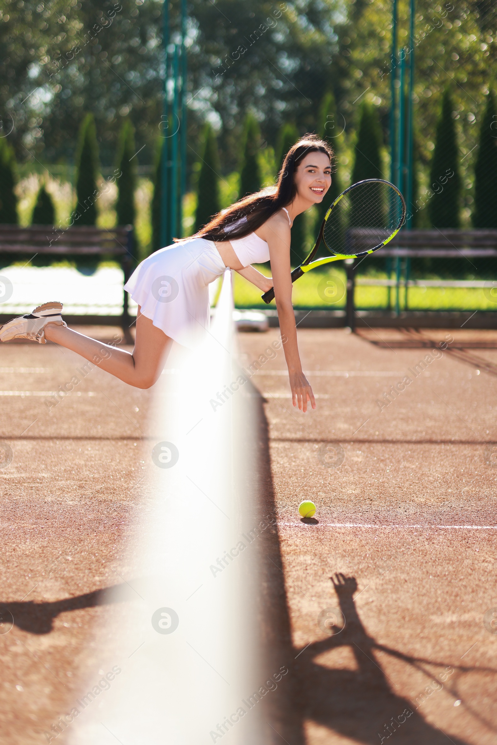 Photo of Tennis player with racket and ball on court