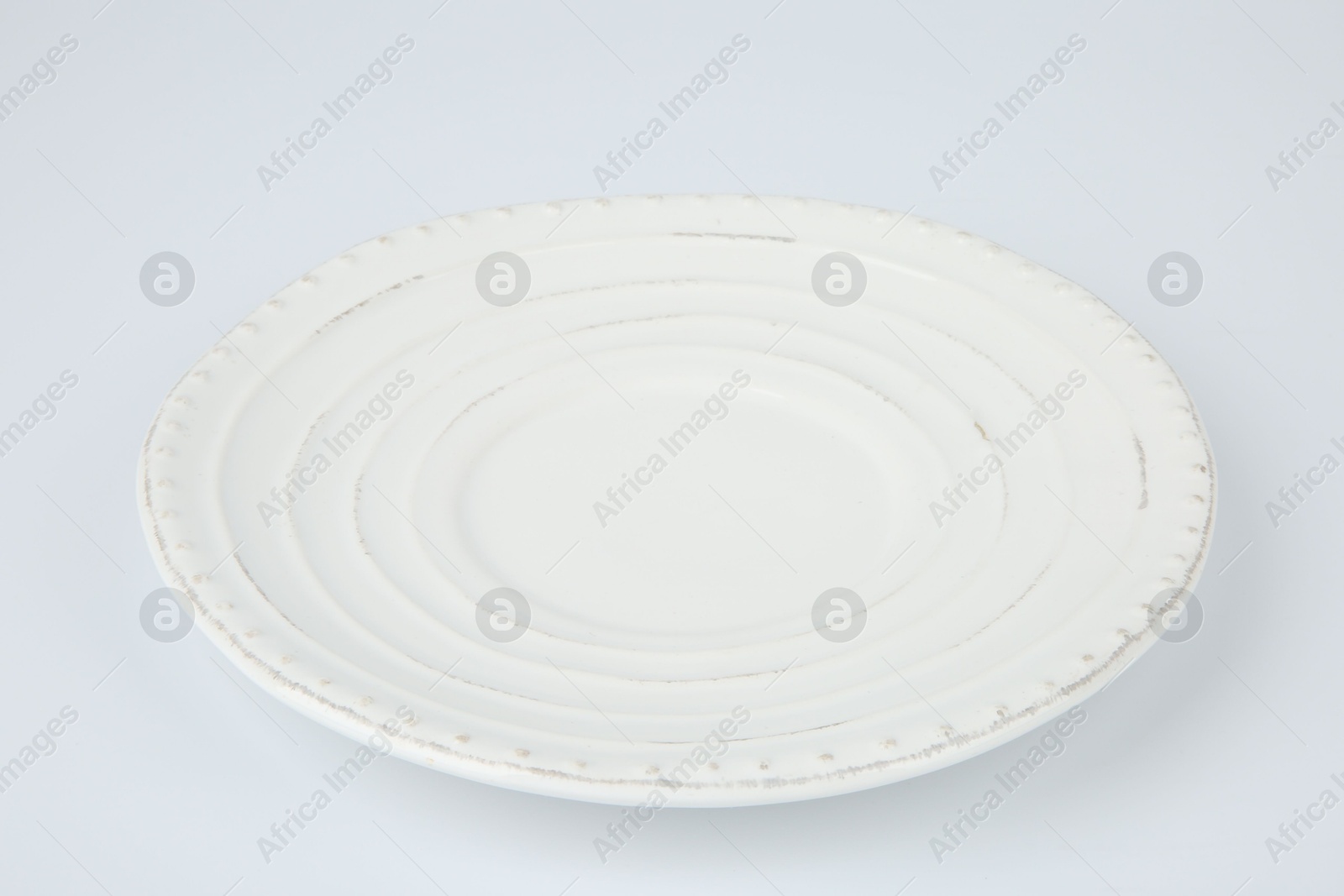 Photo of One empty ceramic plate on white background